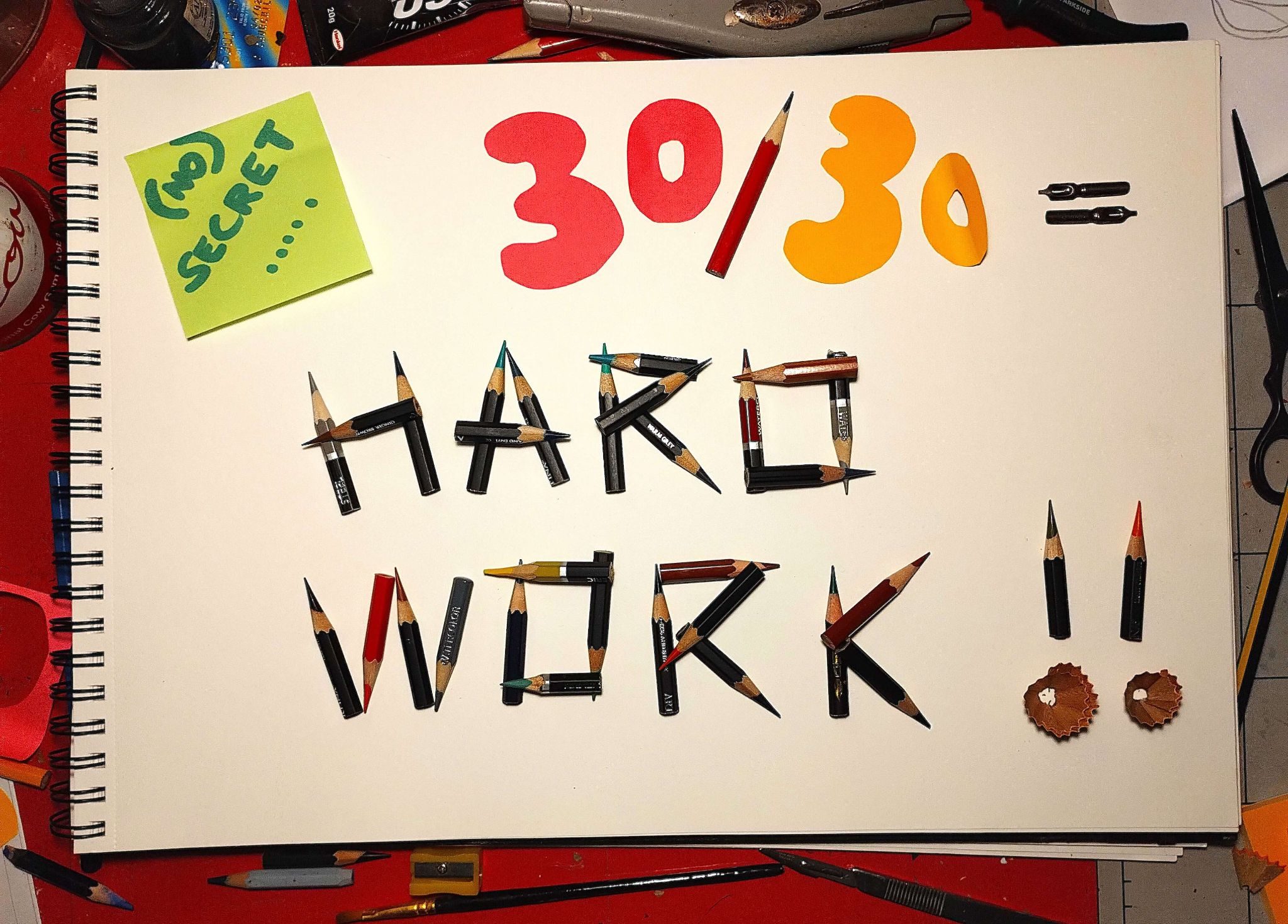 this is a photo of my sketchbook with text created from pencils and paper on it