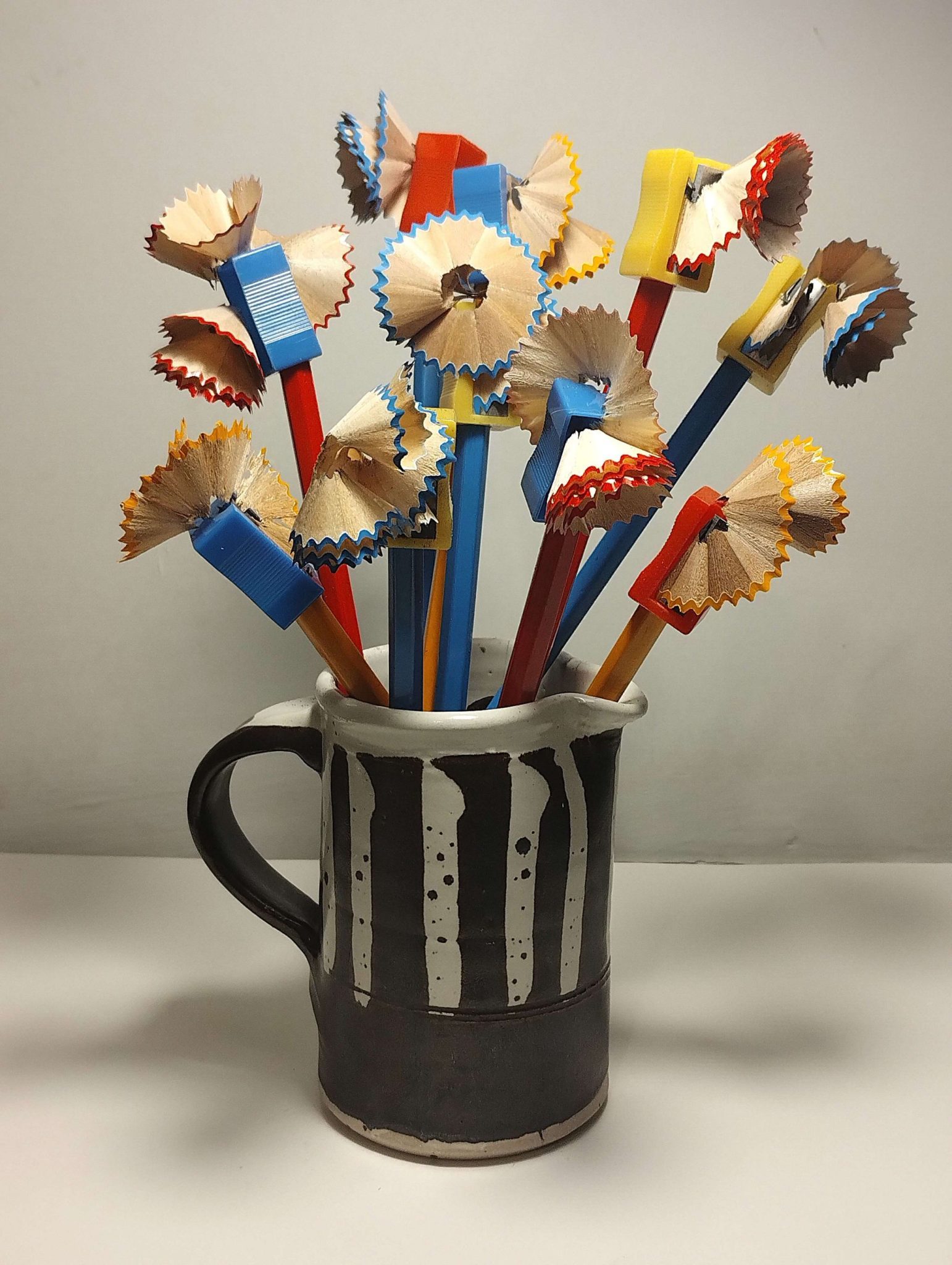 this is a sculpture made from sharpened pencils placed into a jug, to represent a still life painting