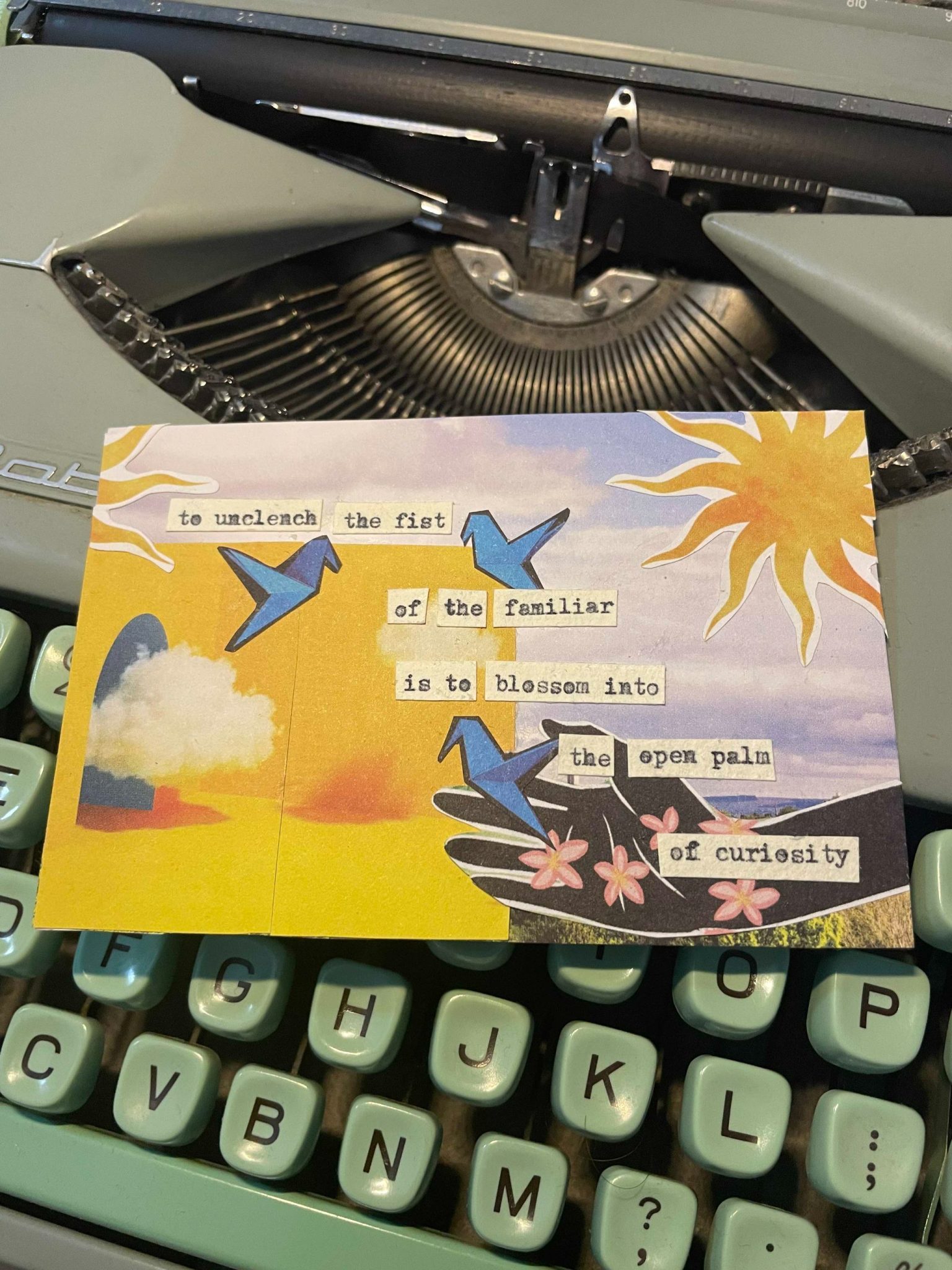 a collage of doors and open hands and the sun with a typewritten poem that says: to unclench the fist of the familiar is to blossom into the open palm of curiosity