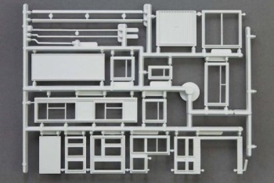 A plastic model sprue containing parts of a house